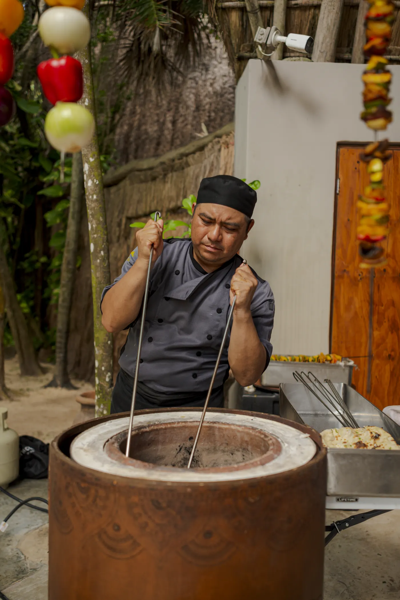 Chef cooking live in the tandoor oven