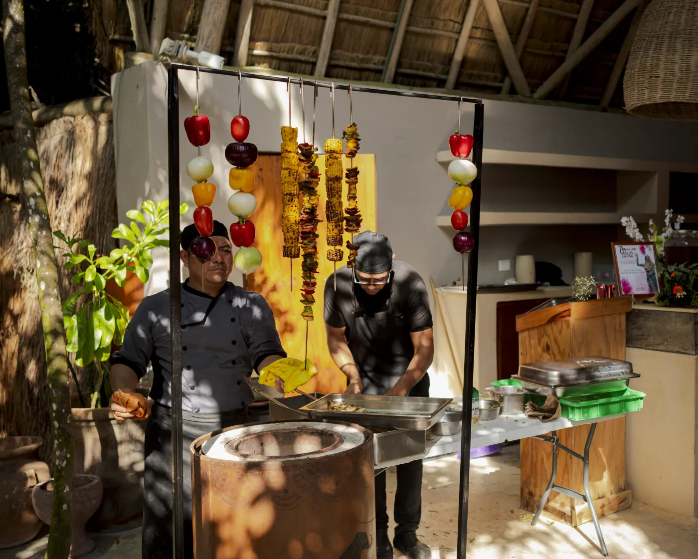 Chefs at an outdoor tandoor station