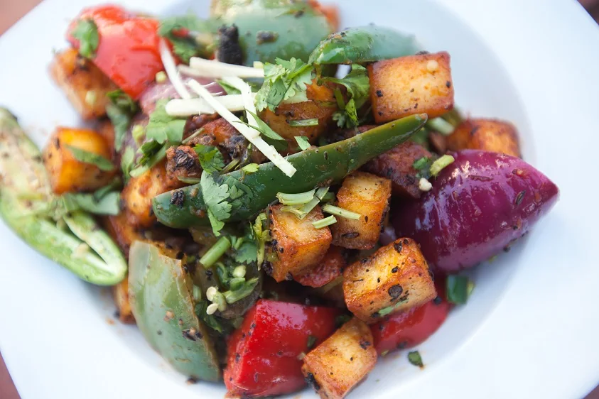 Chilli paneer with peppers and fresh herbs