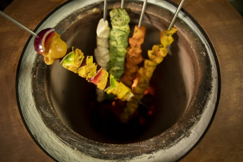Colorful skewers cooking in the tandoor
