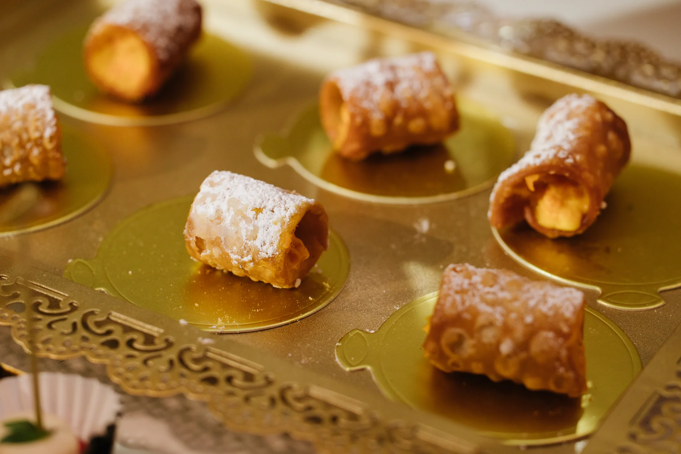 Golden filled pastries with powdered sugar