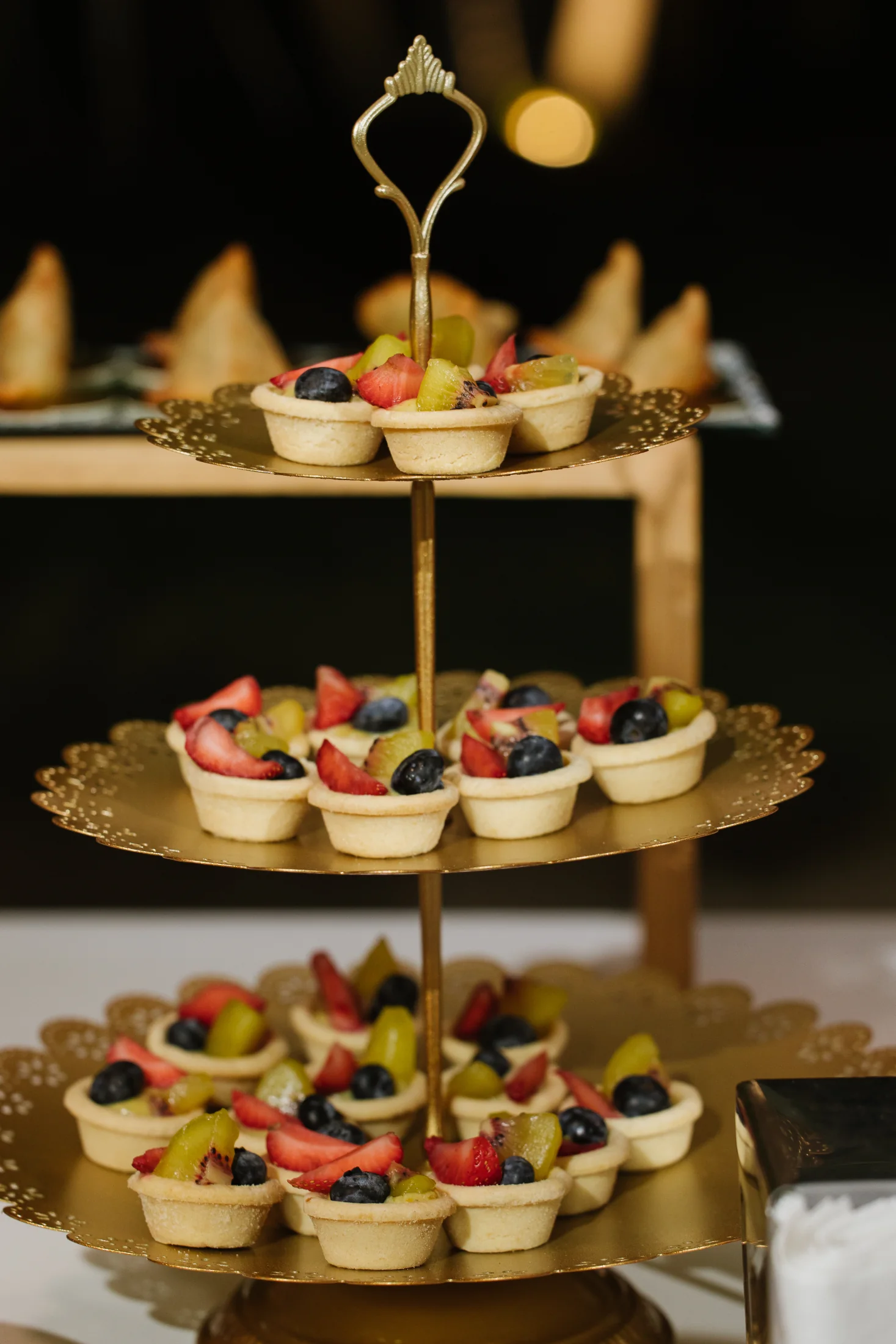 Tiered display of fresh fruit tartlets