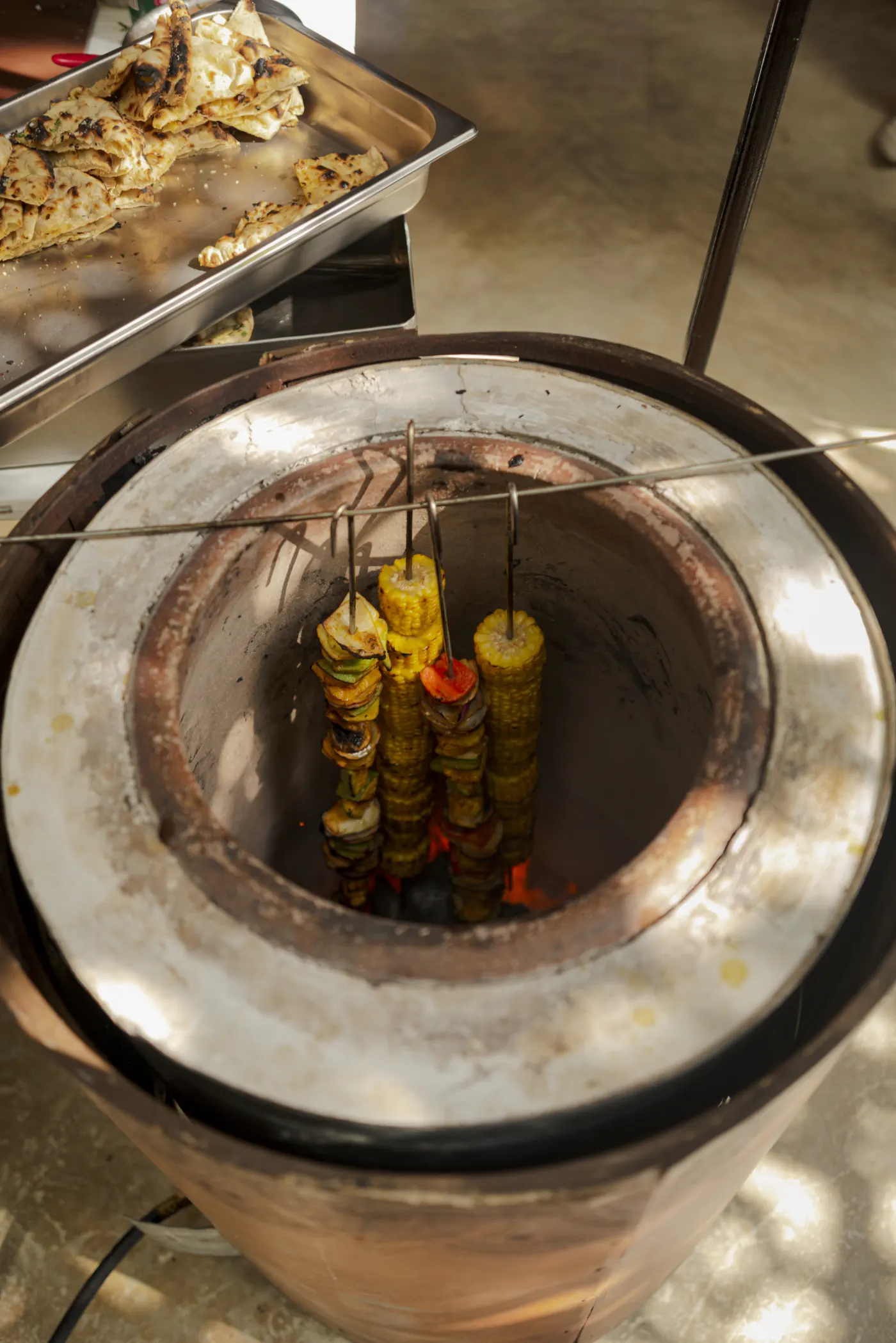 Vegetables roasting inside the tandoor